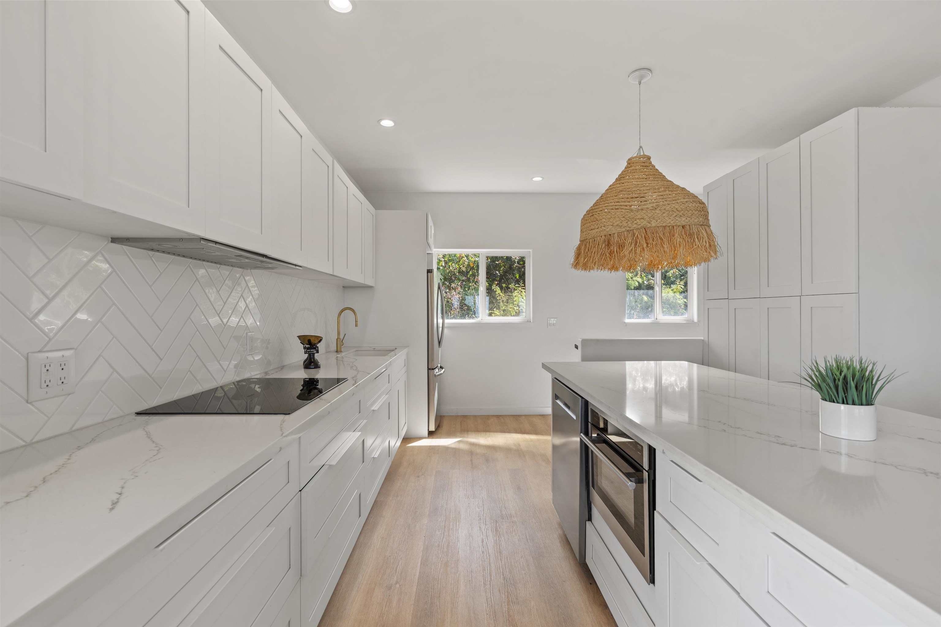 60 East Huapala Place, Unit B Lahaina, HI 96761 - Photo 35 of 50 a kitchen with stainless steel appliances granite countertop a sink a stove and a wooden floors
