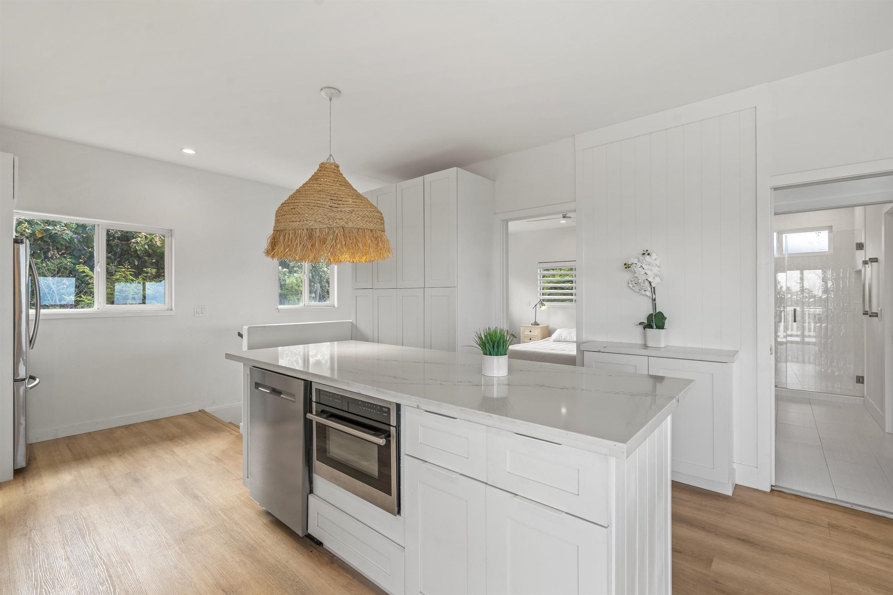 60 East Huapala Place, Unit B Lahaina, HI 96761 - Photo 37 of 50 a kitchen with a sink cabinets and wooden floor