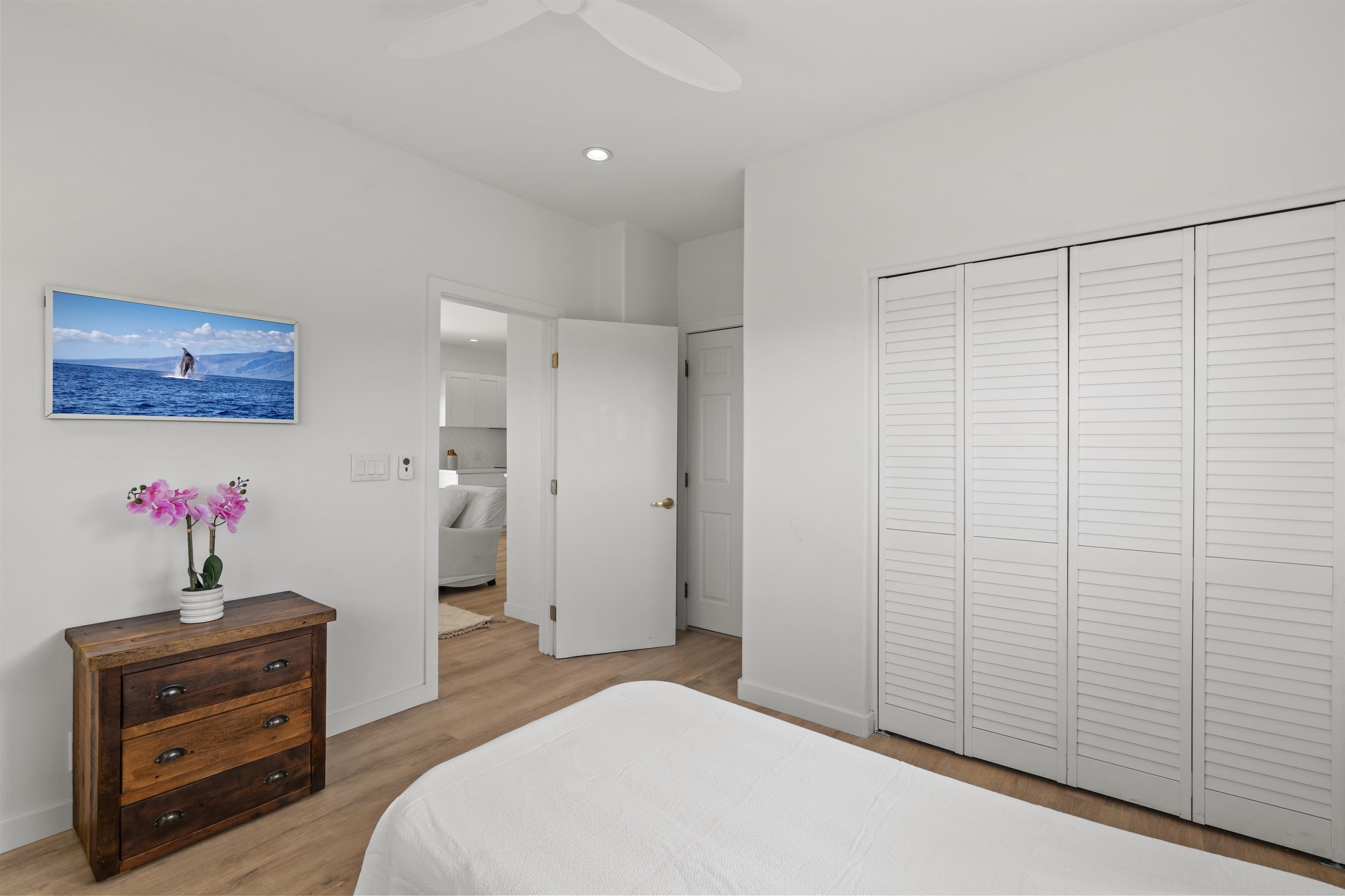 60 East Huapala Place, Unit B Lahaina, HI 96761 - Photo 49 of 50 a bedroom with a bed and a chandelier