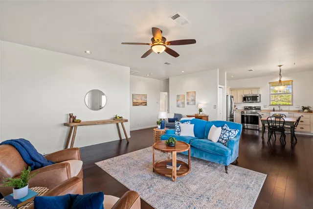a living room with furniture kitchen view and a dining table
