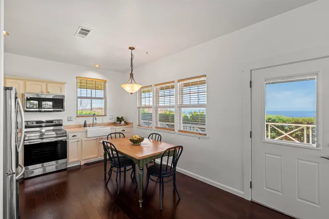 a kitchen with a table chairs stove and microwave