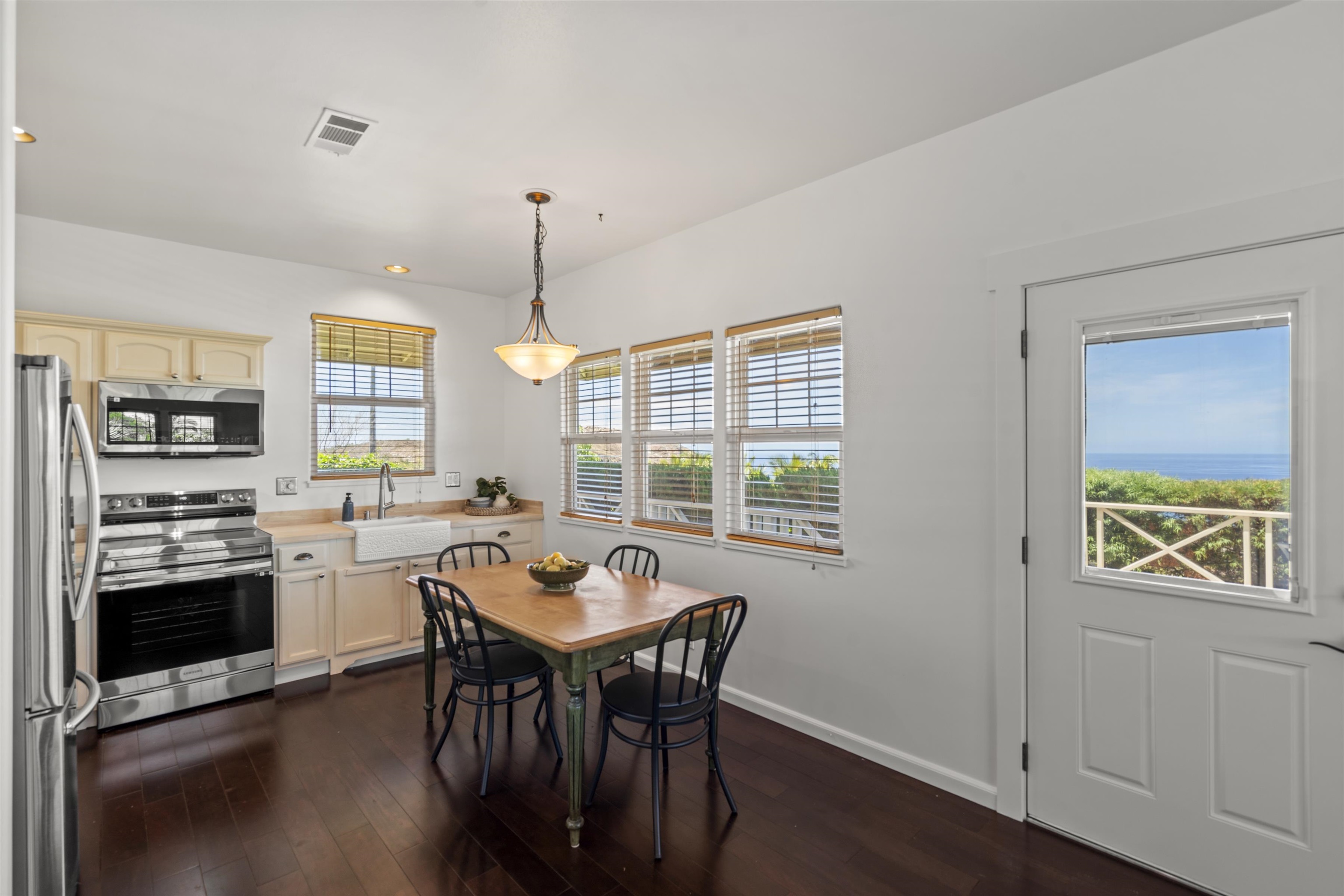 60 East Huapala Place, Unit B Lahaina, HI 96761 - Photo 10 of 50 a kitchen with a table chairs stove and microwave