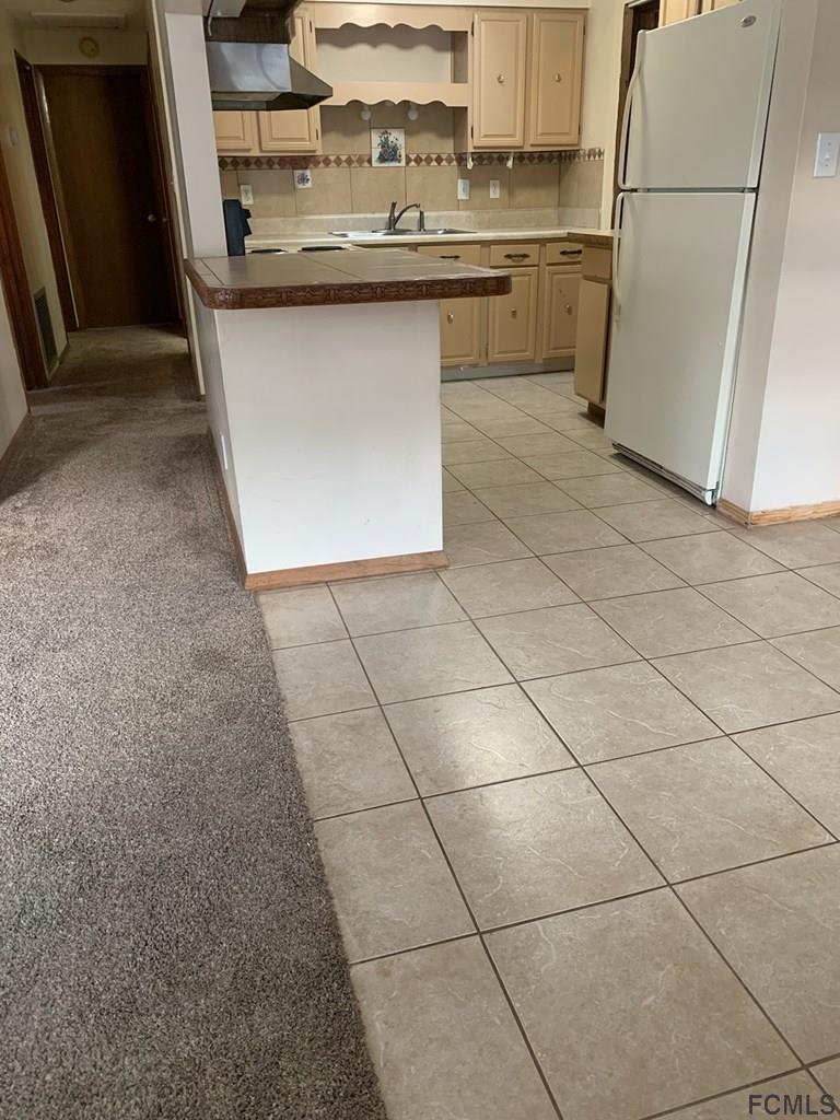 117 Queen Road St. Augustine, FL 32086 - Photo 11 of 16 a kitchen with a sink a stove top oven and cabinets