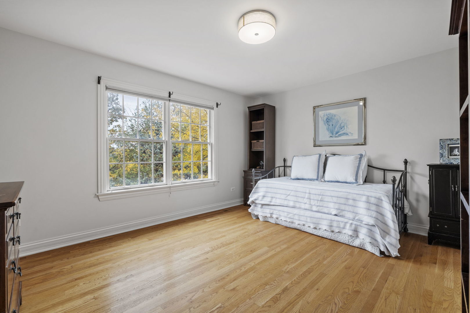 3855 Glendenning Road Downers Grove, IL 60515 - Photo 18 of 39 a bedroom with a bed and wooden floor