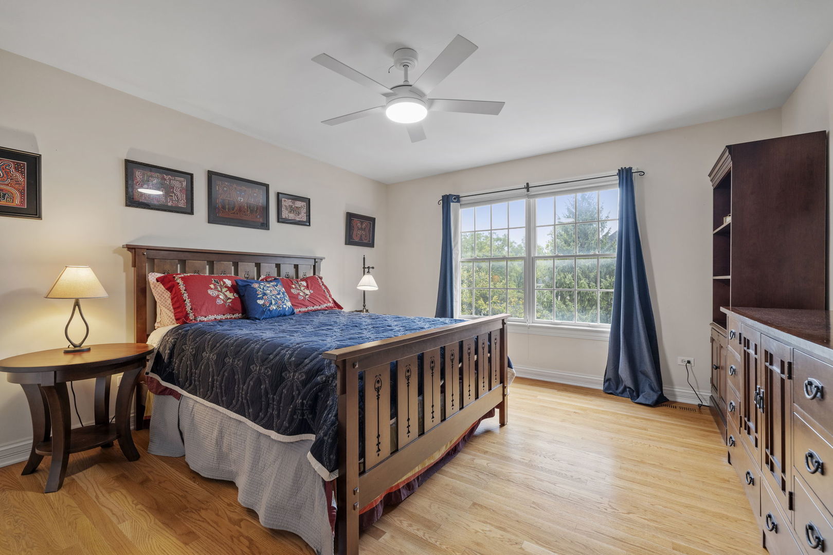 3855 Glendenning Road Downers Grove, IL 60515 - Photo 19 of 39 a bedroom with a bed next to a large window with wooden floor