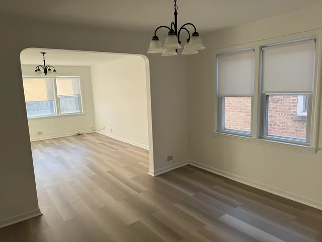 a view of a room with wooden floor and windows