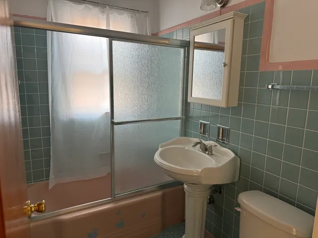a bathroom with a sink toilet and shower