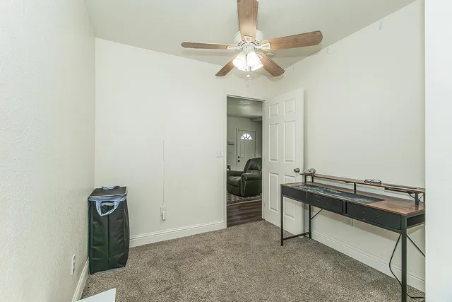 a room with a table and a chandelier