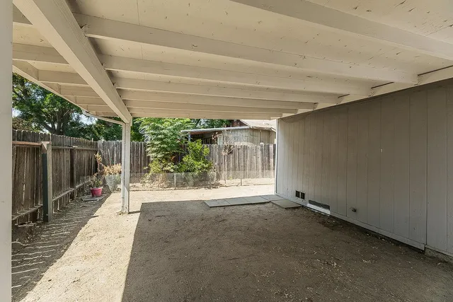 a view of a room with wooden floor and iron stairs
