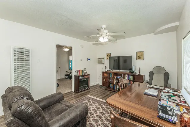 a living room with furniture and a flat screen tv