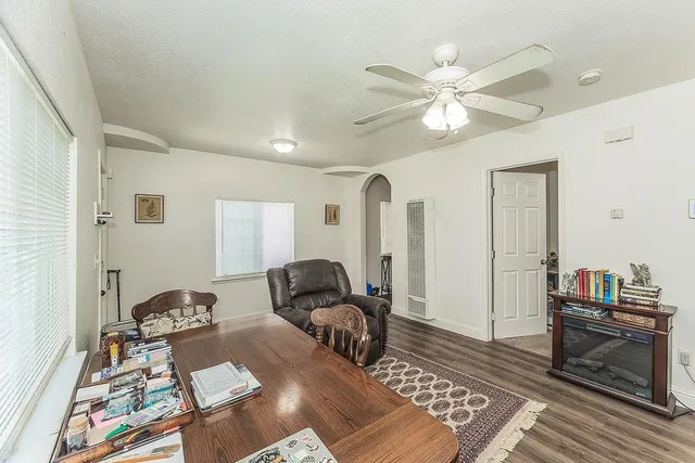 a living room with furniture and wooden floor