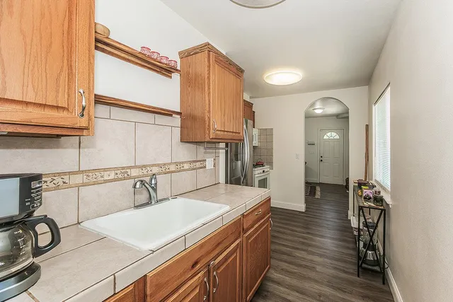 a kitchen with a sink and a refrigerator