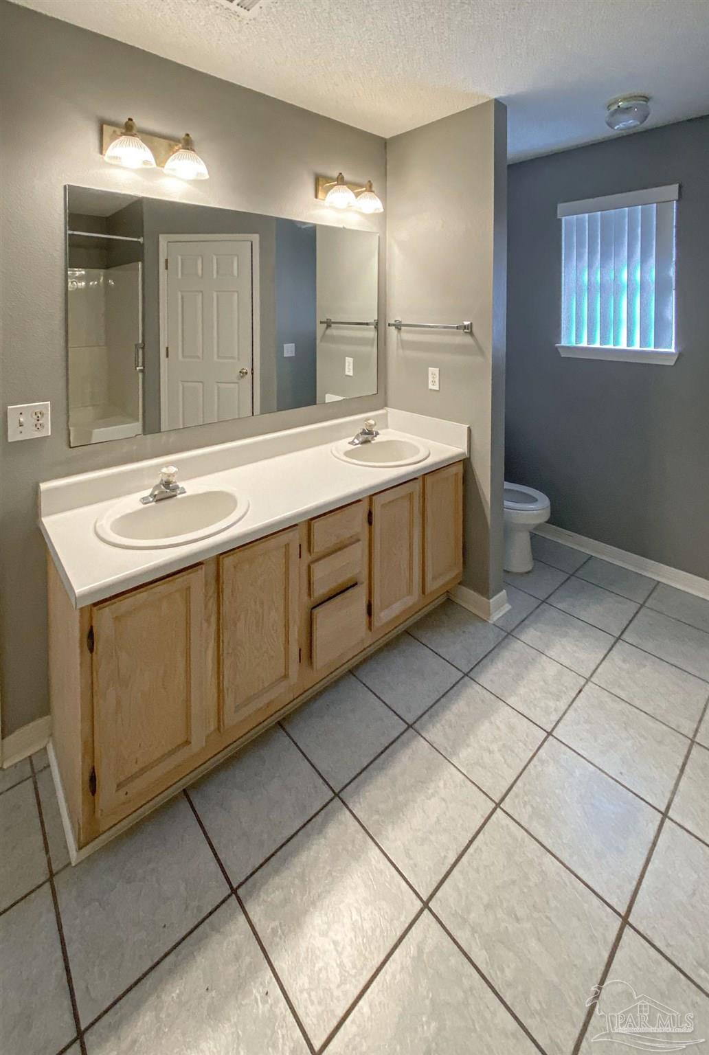 12611 Meadson Road Pensacola, FL 32506 - Photo 13 of 22 a spacious bathroom with a double vanity sink mirror and toilet