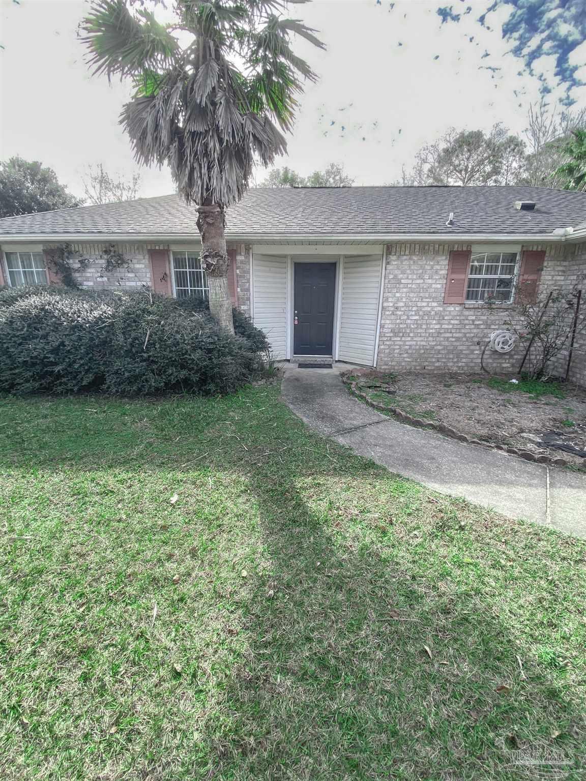 12611 Meadson Road Pensacola, FL 32506 - Photo 2 of 22 a front view of a house with a garden and yard