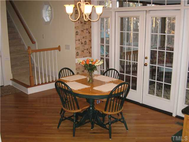 9405 Stone Mountain Road Raleigh, NC 27613 - Photo 5 of 12 Breakfast room has hardwood floors, built-in bookcases and is open to kitchen and family room.