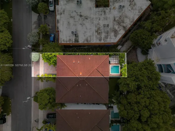 an aerial view of a house with a yard