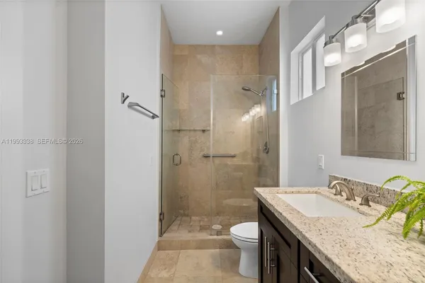 a bathroom with a sink vanity and a mirror