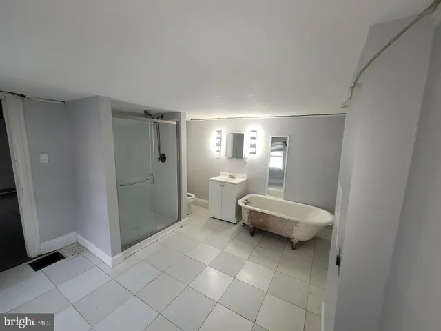 a bathroom with a toilet a sink and glass door