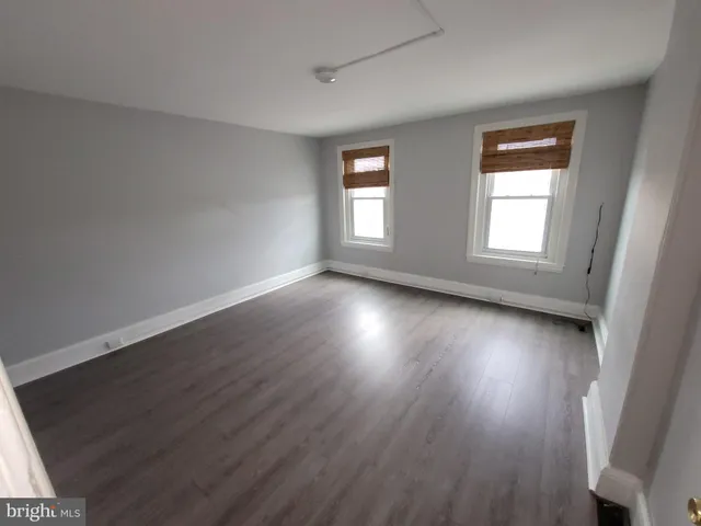 a view of room with window and wooden floor