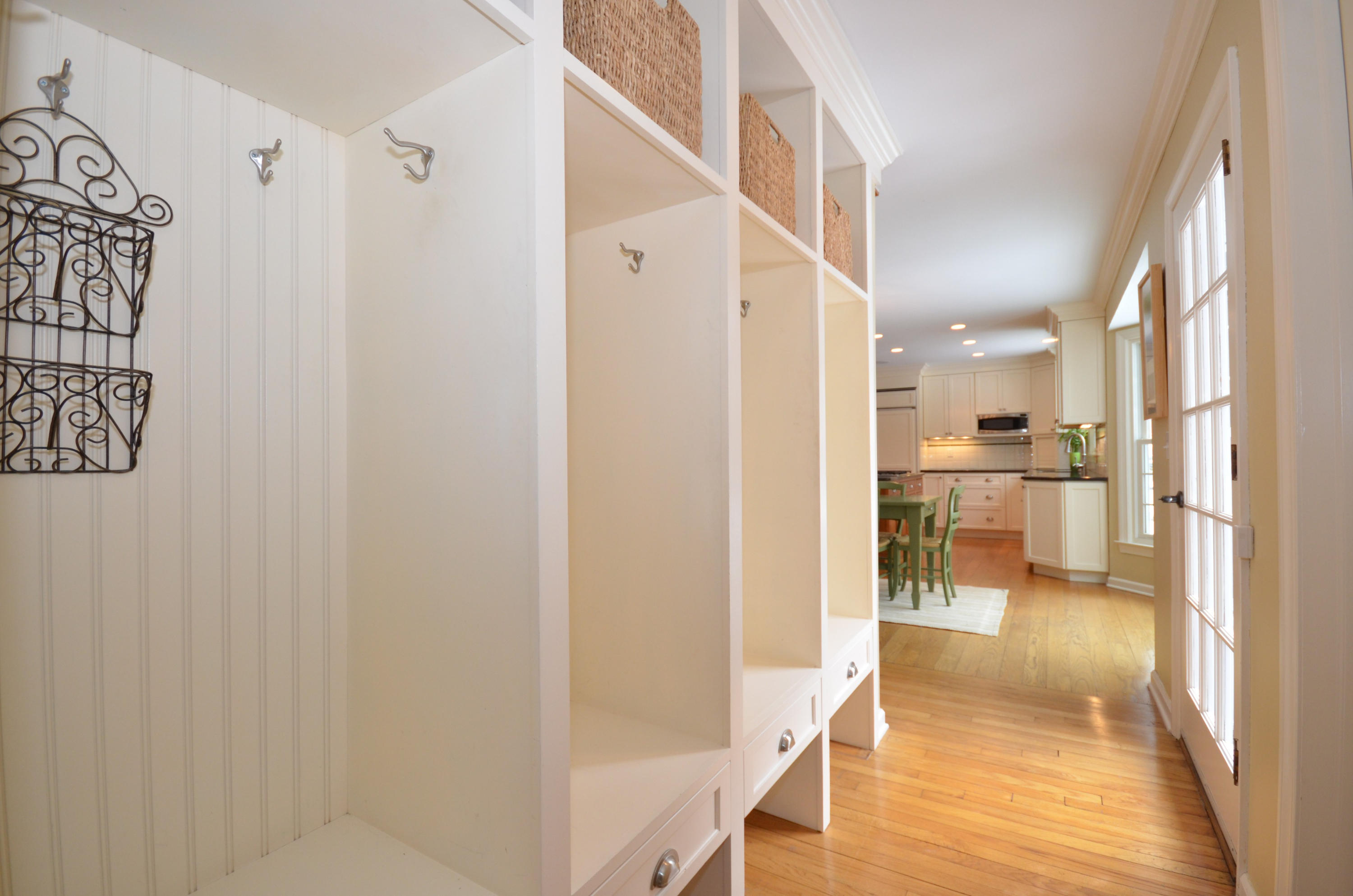 711 Hollow Tree Ridge Road Darien, CT 06820 - Photo 12 of 27 a view of a hallway with wooden floor windows and a livingroom