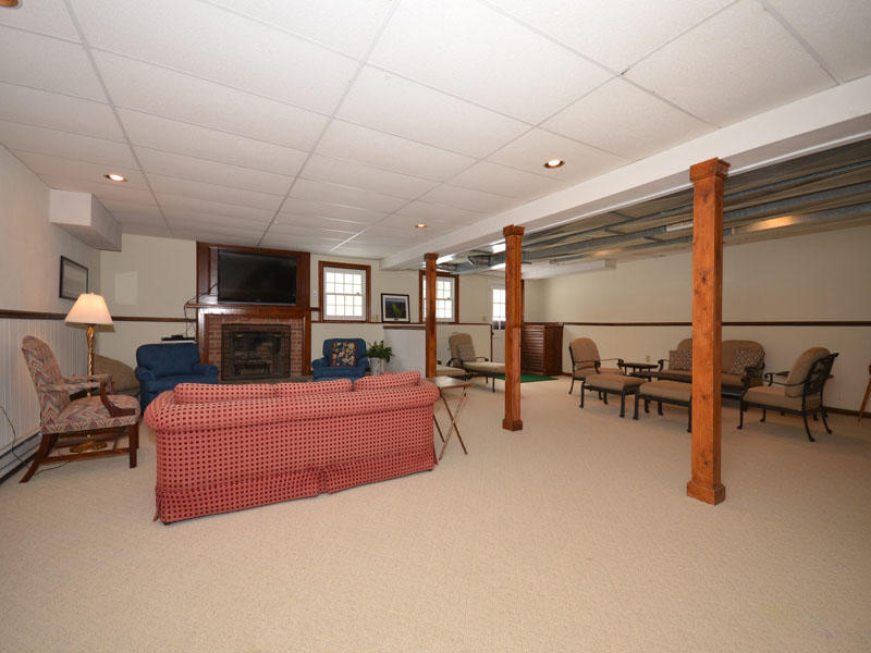 711 Hollow Tree Ridge Road Darien, CT 06820 - Photo 13 of 27 a living room with furniture and a flat screen tv