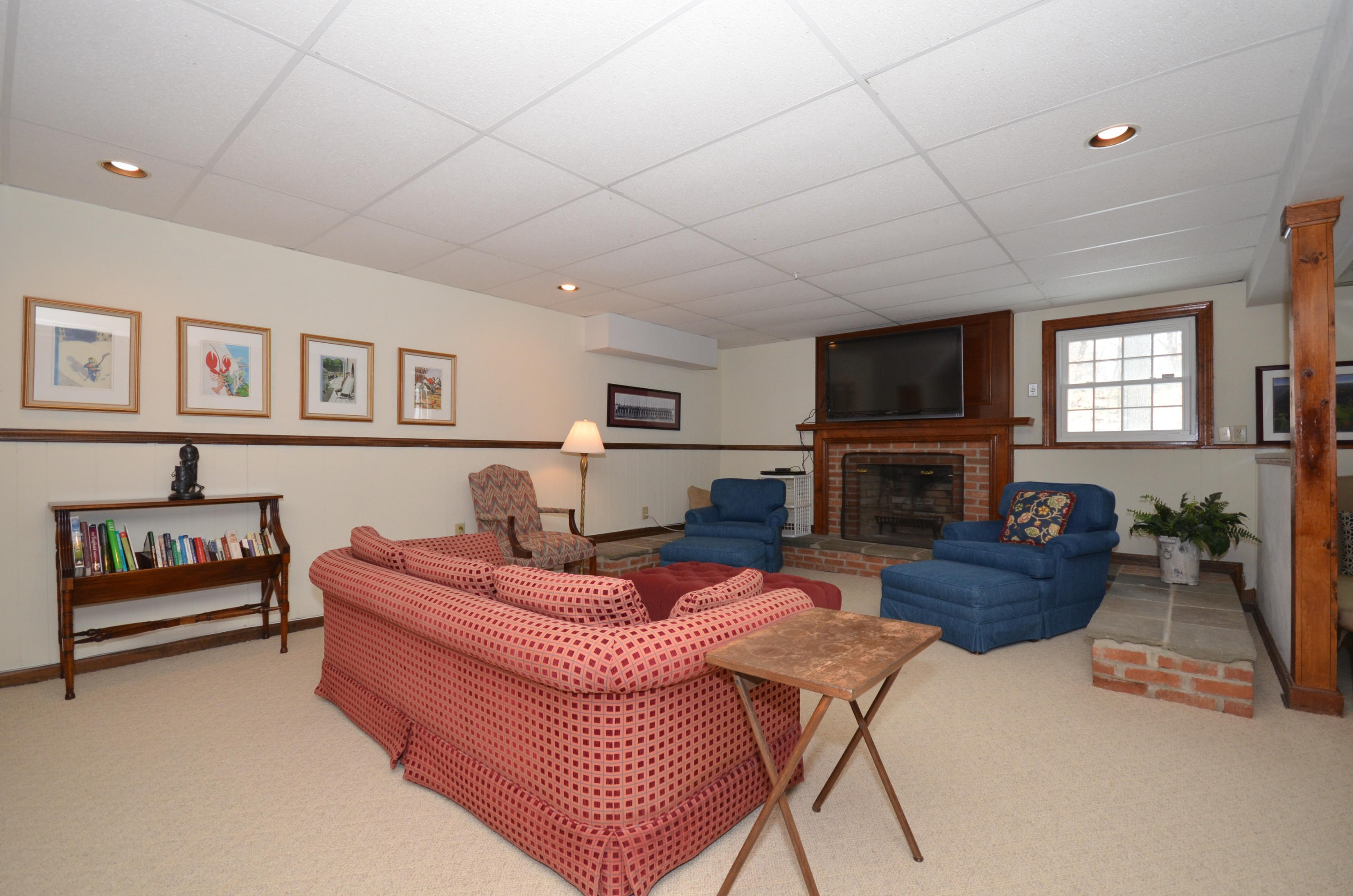 711 Hollow Tree Ridge Road Darien, CT 06820 - Photo 14 of 27 a living room with furniture and a flat screen tv