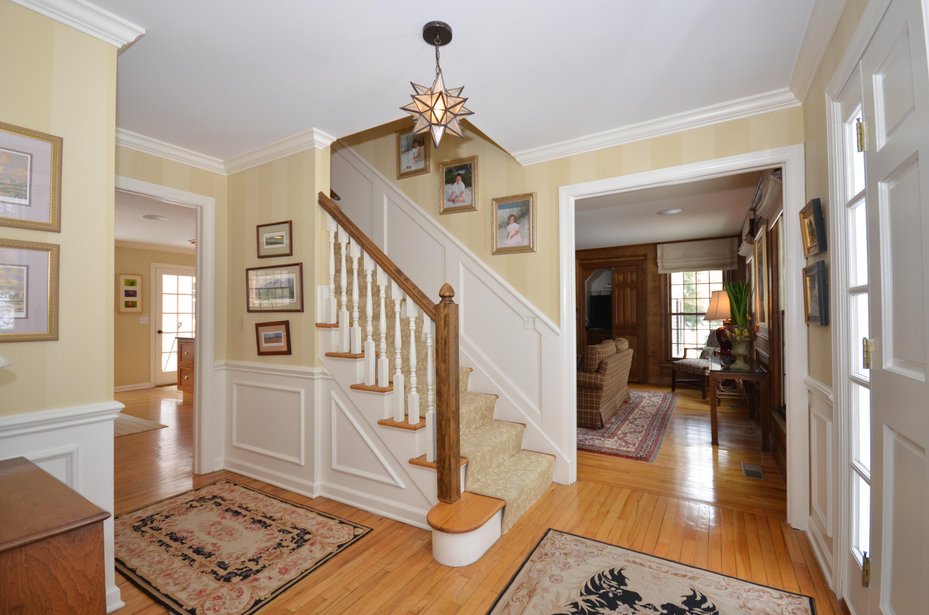 711 Hollow Tree Ridge Road Darien, CT 06820 - Photo 2 of 27 a view of an entryway with wooden floor and a livingroom