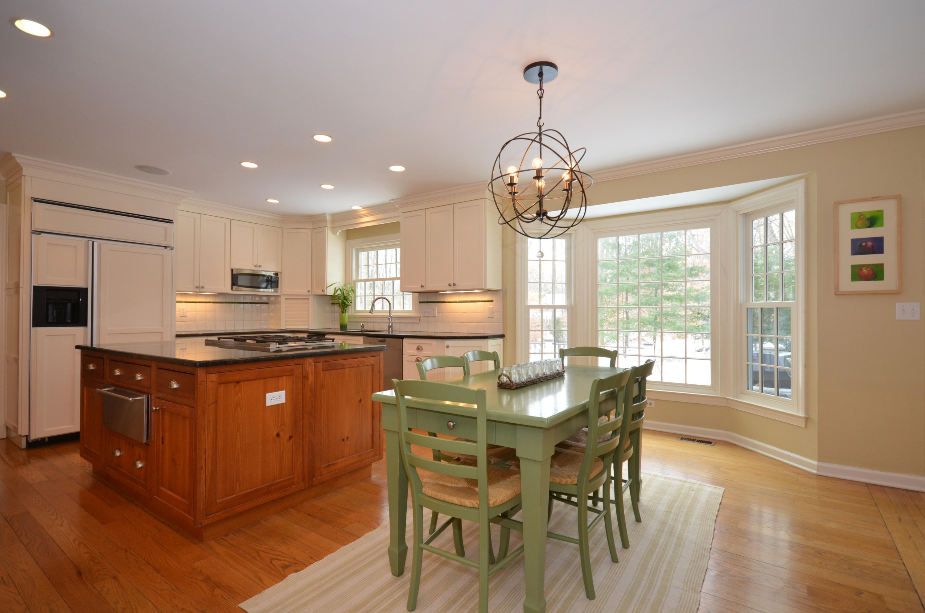 711 Hollow Tree Ridge Road Darien, CT 06820 - Photo 8 of 27 a kitchen with stainless steel appliances granite countertop wooden floor dining table and chairs