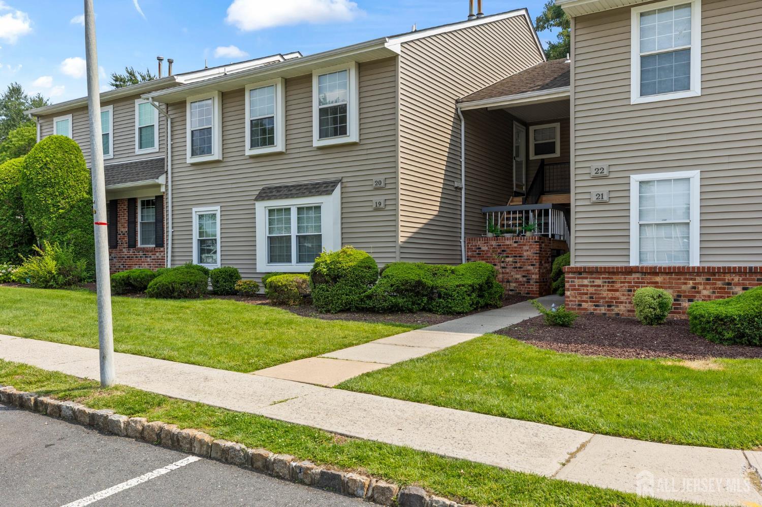20 Lindsey Circle, Unit 20 Old Bridge, NJ 08857 - Photo 1 of 22 a front view of a house with a garden and yard