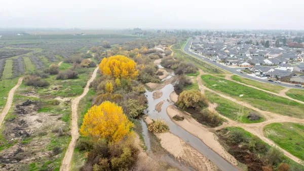an aerial view of residential houses with outdoor space