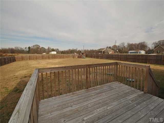 1129 Sandel Lane Raleigh, NC 27603 - Photo 12 of 12 The back deck overlooks the huge fenced backyard.
