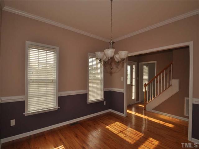1129 Sandel Lane Raleigh, NC 27603 - Photo 2 of 12 The formal dining room features gorgeous hardwood floors, ample moldings and a lovely chandelier.