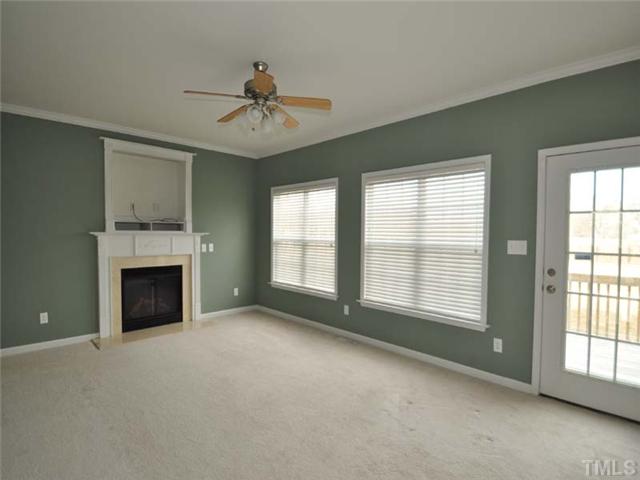 1129 Sandel Lane Raleigh, NC 27603 - Photo 4 of 12 The lovely family room features 9 foot ceilings, gas log fireplace with entertainment niche, and access to the deck overlooking the large fenced backyard.