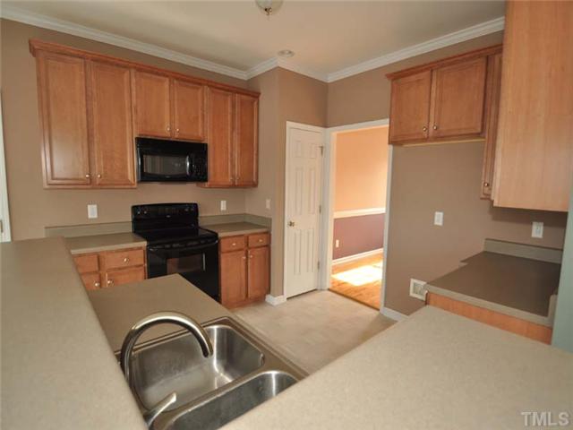 1129 Sandel Lane Raleigh, NC 27603 - Photo 5 of 12 The spacious kitchen offers a smooth top stove, plenty of counter space and a built in microwave.
