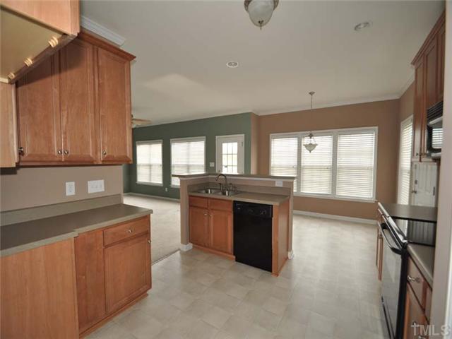 1129 Sandel Lane Raleigh, NC 27603 - Photo 6 of 12 The spacious kitchen offers a smooth top stove, plenty of counter space and a built in microwave.