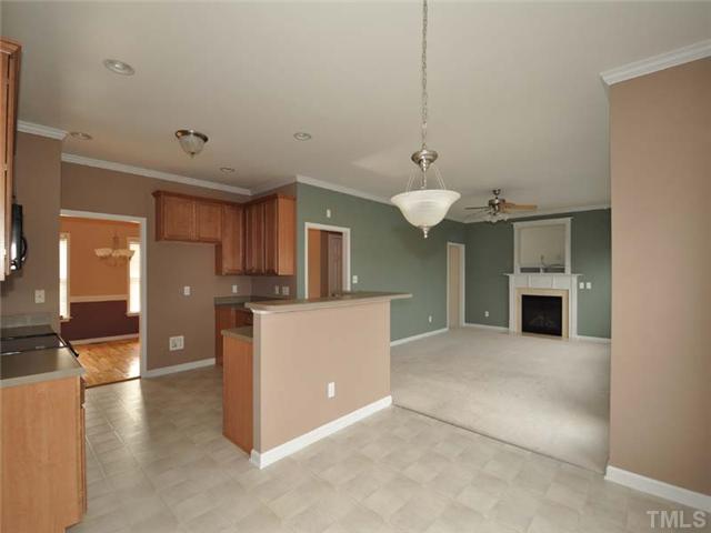 1129 Sandel Lane Raleigh, NC 27603 - Photo 8 of 12 The lovely family room features 9 foot ceilings, gas log fireplace with entertainment niche, and access to the deck overlooking the large fenced backyard.