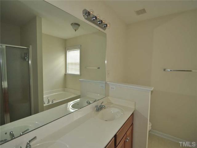 1129 Sandel Lane Raleigh, NC 27603 - Photo 10 of 12 The huge master bedroom has plenty of usable wall space, a spacious walk in closet, and lovely bath with garden tub and separate shower.