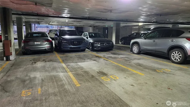 a view of parking garage with cars