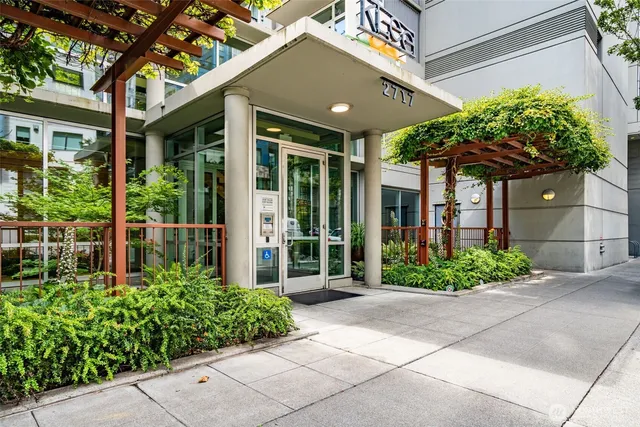 a couple of potted plants in front of a brick building