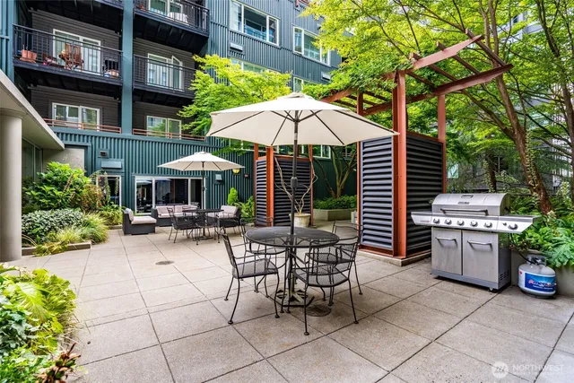 a view of a patio with couches chairs and potted plants