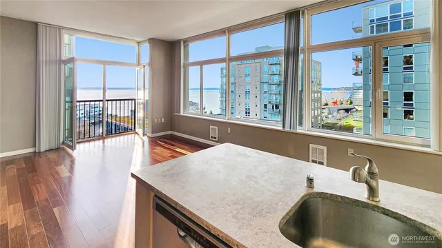 a view of a kitchen with granite countertop a sink and a large window