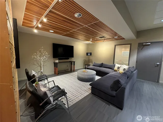 a view of a room with furniture and a flat screen tv