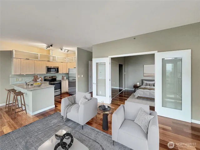 a living room with furniture and kitchen view