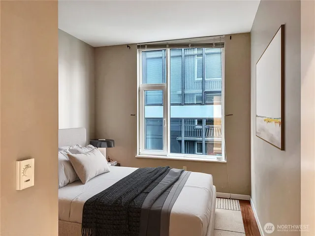 a bedroom with a bed and a window