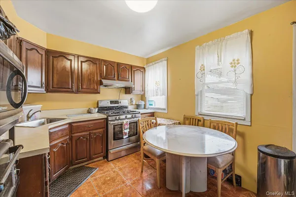 a kitchen with a sink stove and cabinets