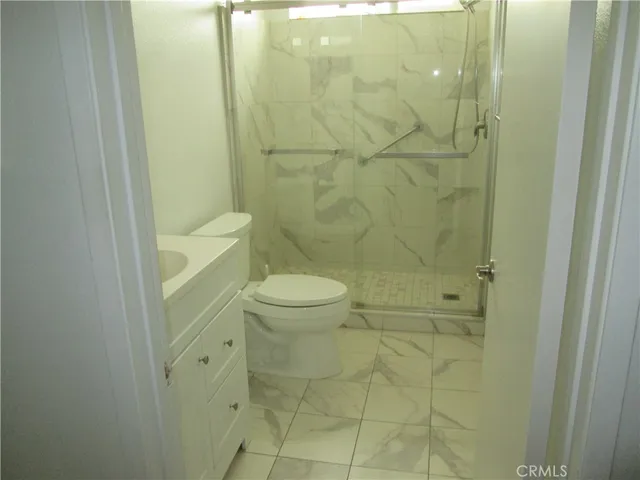 a kitchen with stainless steel appliances granite countertop a stove top oven a sink a dining table and chairs