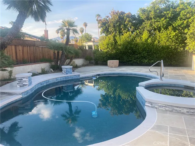 a view of a swimming pool with a patio
