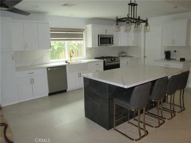 a kitchen with a sink a stove a microwave and cabinets
