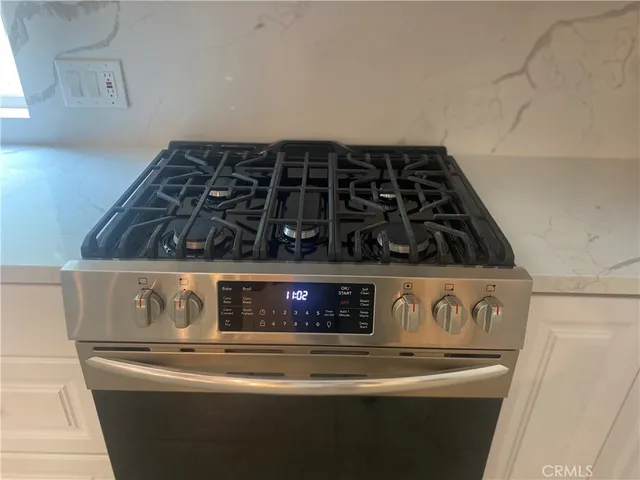 a kitchen with a sink and chairs