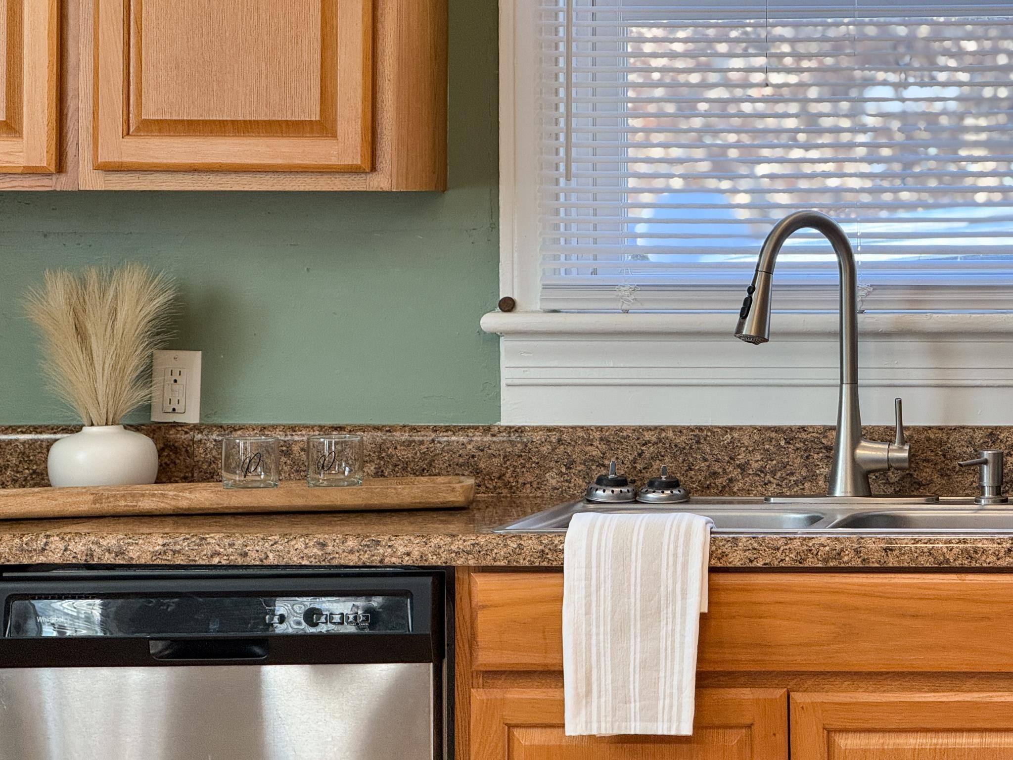 703 Monroe Street Staunton, VA 24401 - Photo 11 of 21 a kitchen with granite countertop a stove a microwave a sink and cabinets